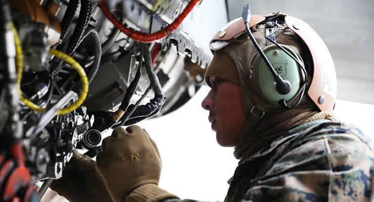 Soldier works on engine