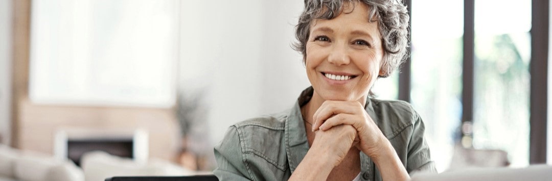 Friendly woman sitting behind laptop computer